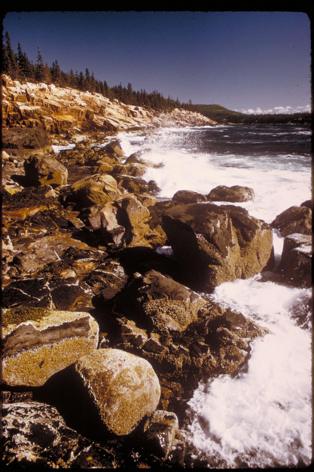 Waves over granite boulders in Acadia National Park